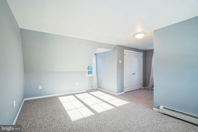 bonus room featuring baseboard heating, light colored carpet, and lofted ceiling