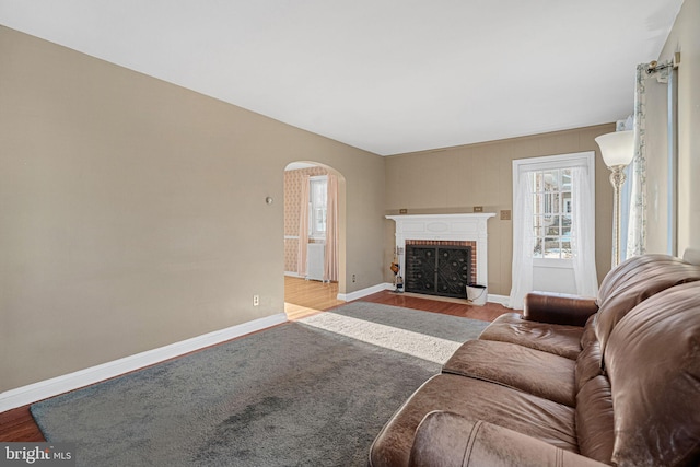 living room featuring light wood-type flooring and a fireplace