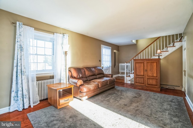 living room featuring baseboard heating, radiator, and dark wood-type flooring