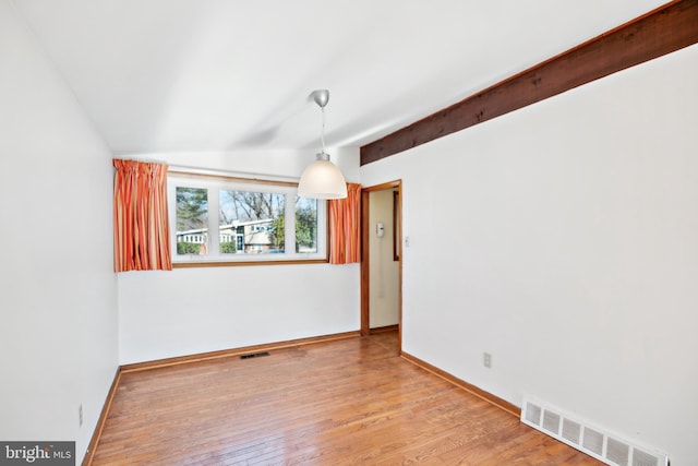 unfurnished dining area with light hardwood / wood-style flooring and lofted ceiling