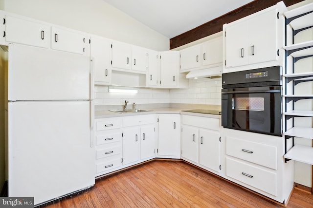 kitchen featuring black appliances, white cabinets, sink, light hardwood / wood-style flooring, and tasteful backsplash