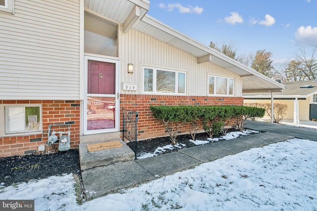 view of snow covered property entrance