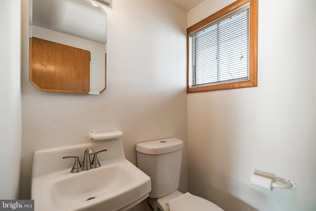 bathroom featuring toilet and sink