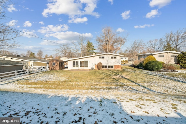 view of snow covered back of property