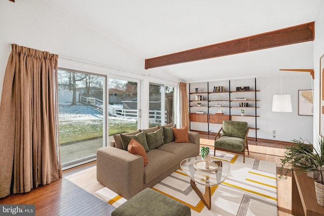 living room featuring light wood-type flooring and vaulted ceiling