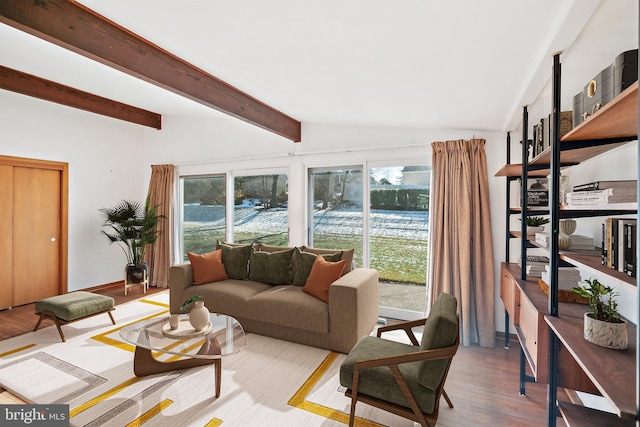 living room featuring vaulted ceiling with beams and light wood-type flooring