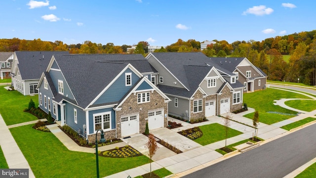 view of front of property with a front yard and a garage