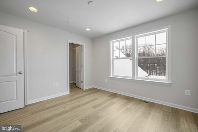 spare room with light hardwood / wood-style floors