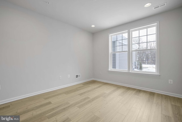 spare room featuring light hardwood / wood-style floors