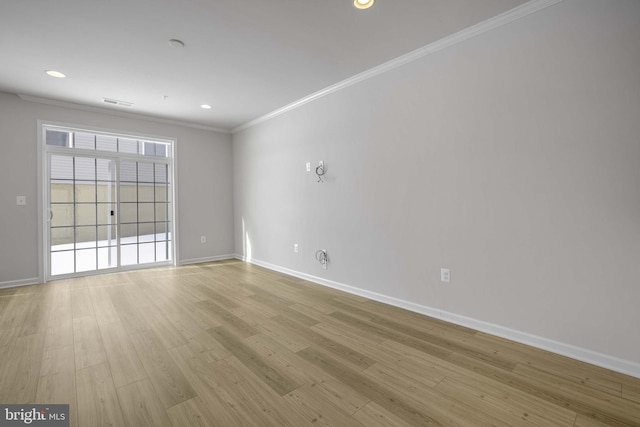 empty room with light wood-type flooring and ornamental molding