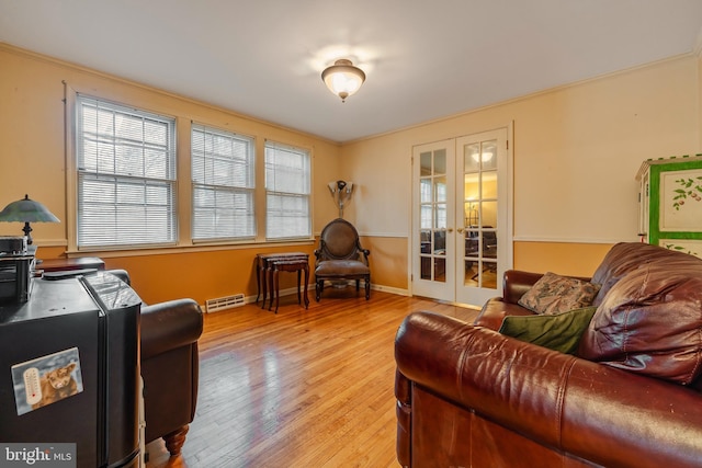 living area featuring french doors and light hardwood / wood-style floors