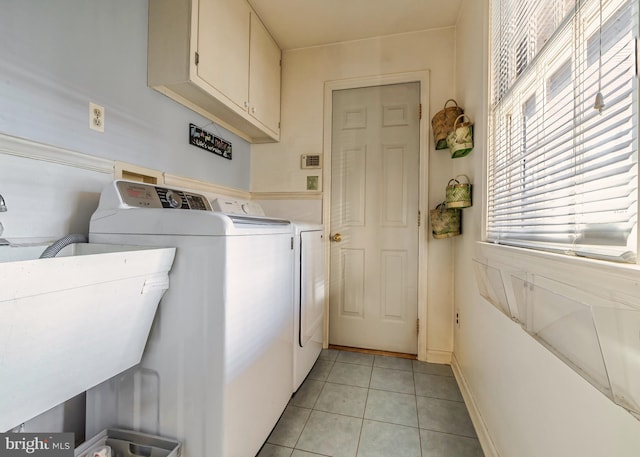 washroom with cabinets, independent washer and dryer, sink, and light tile patterned flooring