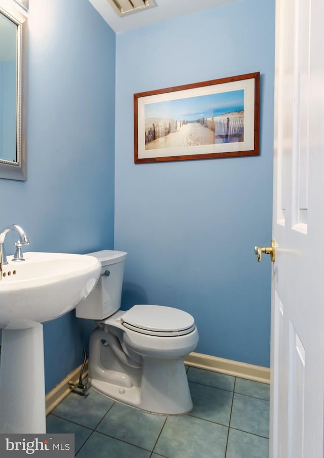 bathroom featuring sink, tile patterned flooring, and toilet