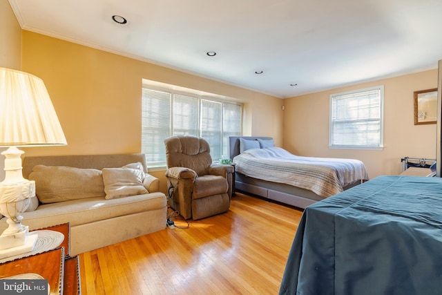 bedroom with crown molding and hardwood / wood-style flooring