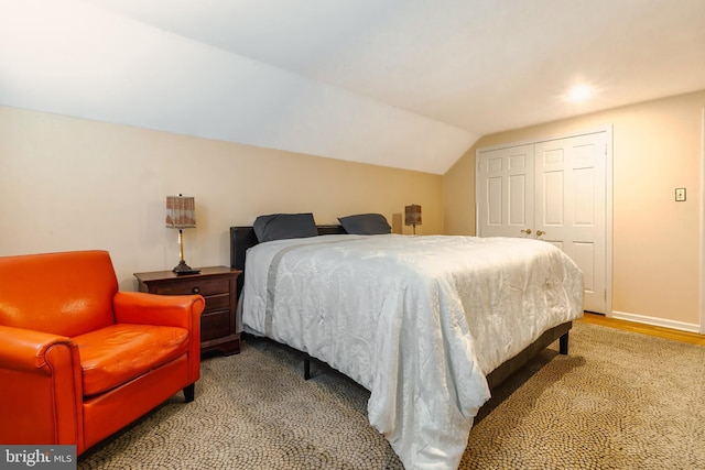 bedroom with a closet and lofted ceiling