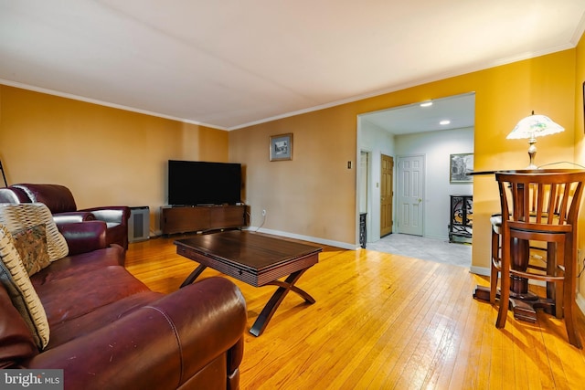 living room with light wood-type flooring and ornamental molding