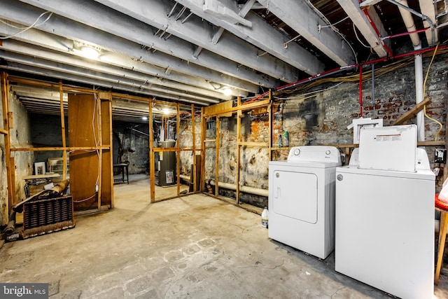 basement with washer and clothes dryer and gas water heater