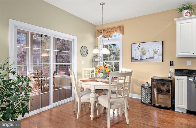 dining area featuring hardwood / wood-style flooring and wine cooler