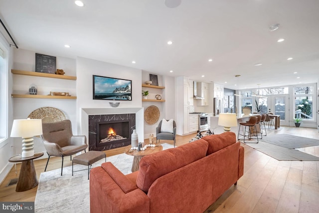 living room with a fireplace and light hardwood / wood-style floors