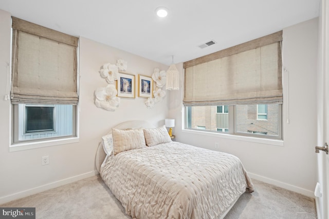 bedroom featuring light carpet