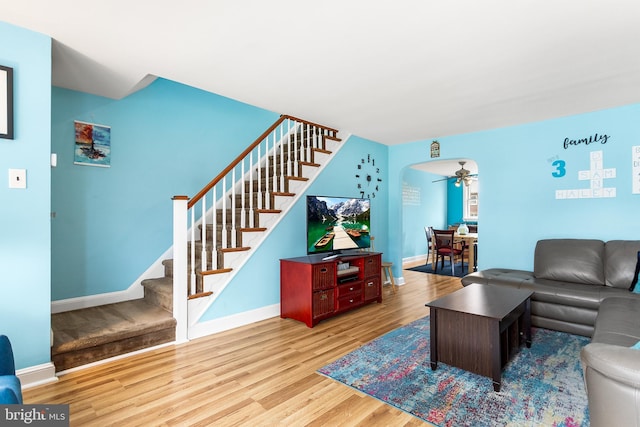 living room featuring ceiling fan and light hardwood / wood-style floors