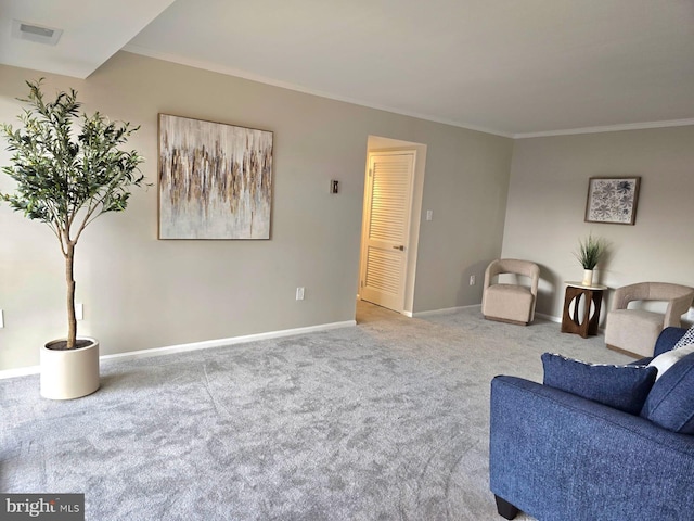 carpeted living room featuring ornamental molding