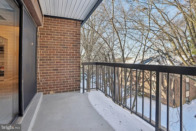 view of snow covered back of property