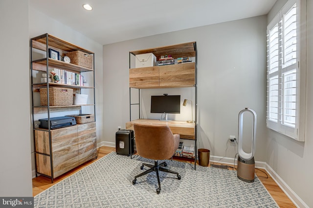 home office featuring baseboards, wood finished floors, and recessed lighting