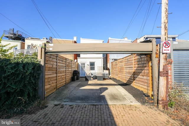 exterior space featuring fence and a detached carport