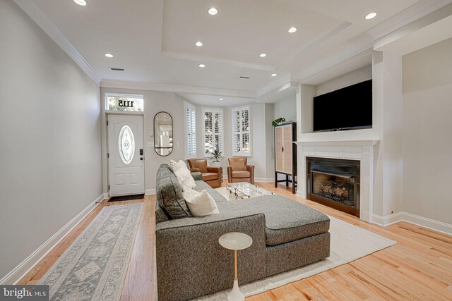 living room featuring recessed lighting, baseboards, a fireplace, and light wood-type flooring
