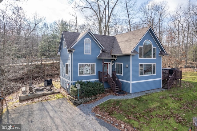 front of property with a fire pit and a front yard