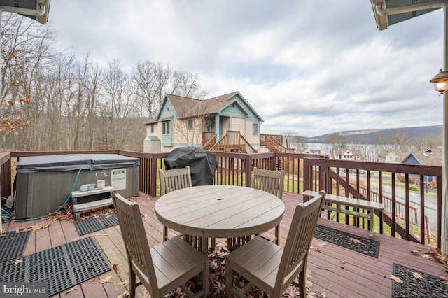 wooden terrace featuring a mountain view, a hot tub, and grilling area