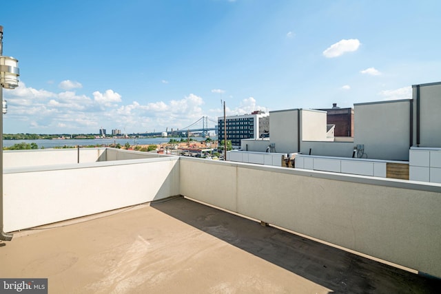 view of patio featuring a water view and a balcony