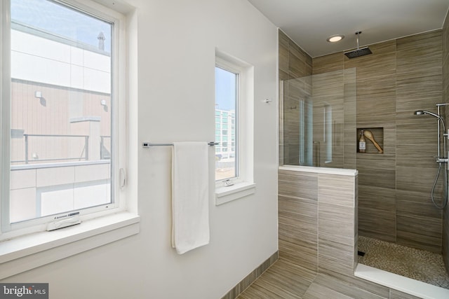 bathroom with tile patterned floors and a tile shower