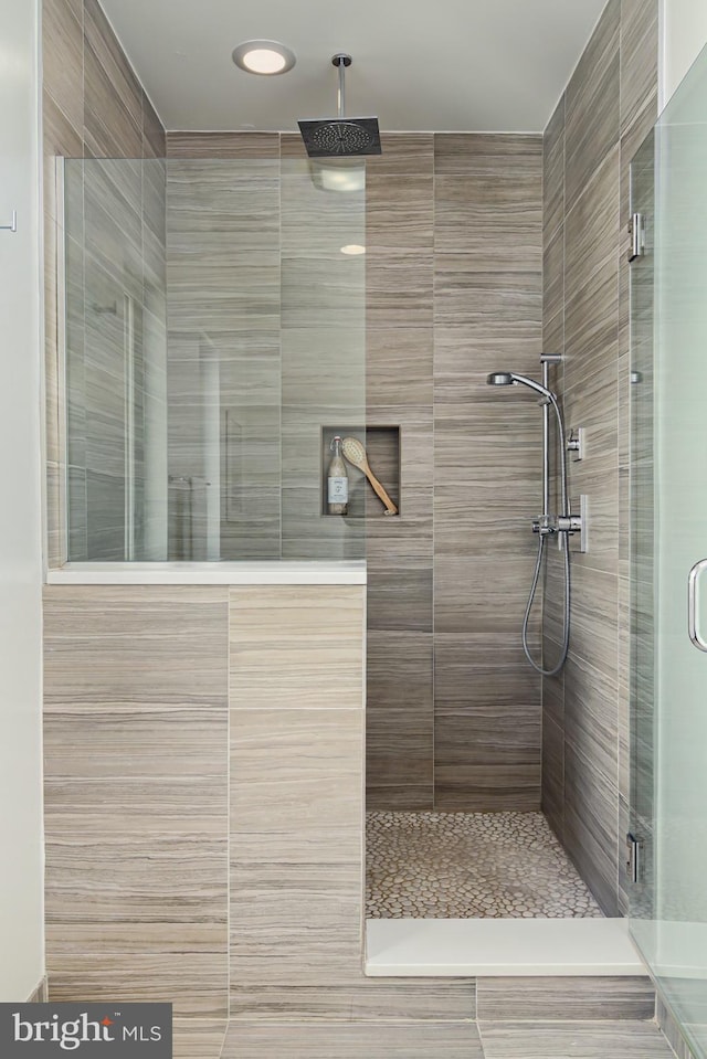 bathroom with a shower with shower door