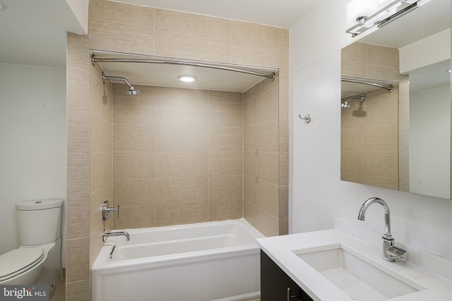 full bathroom with vanity, tiled shower / bath combo, and toilet