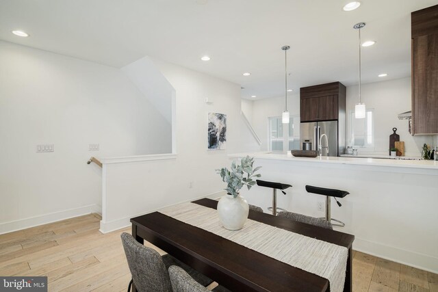 dining area with light hardwood / wood-style flooring