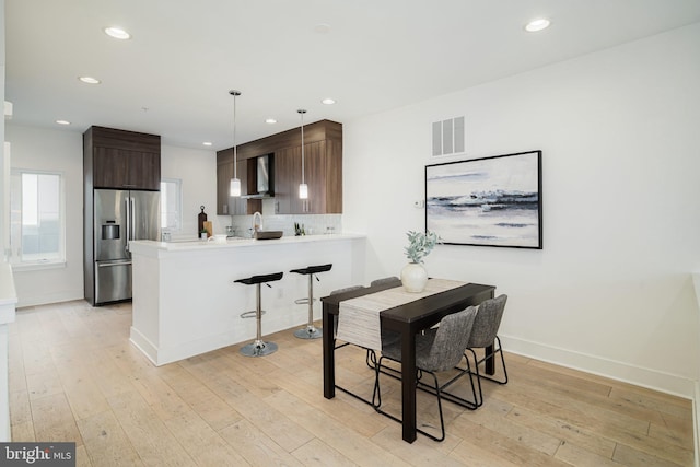 dining space featuring light hardwood / wood-style floors