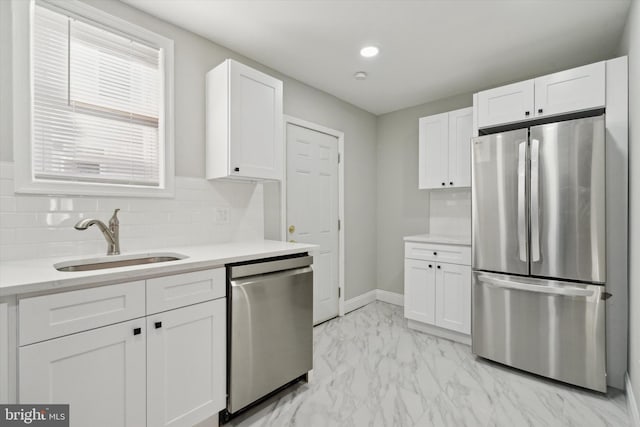 kitchen featuring white cabinets, appliances with stainless steel finishes, and sink