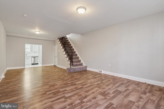 unfurnished living room featuring hardwood / wood-style flooring