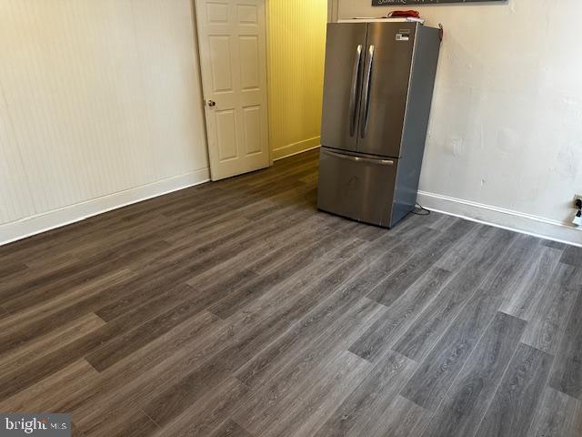 kitchen featuring dark hardwood / wood-style flooring and stainless steel refrigerator