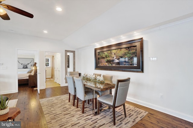 dining area with ceiling fan, wood-type flooring, and lofted ceiling