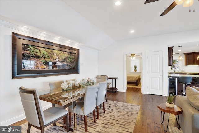 dining space with ceiling fan, sink, beverage cooler, dark hardwood / wood-style flooring, and lofted ceiling