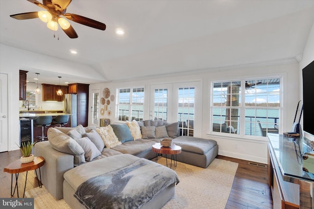 living room with a healthy amount of sunlight, ceiling fan, sink, and dark wood-type flooring