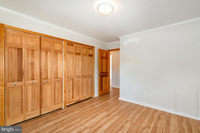 939 Starbit Rd, Towson, MD 21286 - unfurnished bedroom with a closet, baseboards, ornamental molding, and light wood-style floors