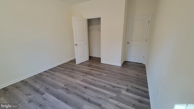 unfurnished bedroom featuring a closet and light hardwood / wood-style flooring