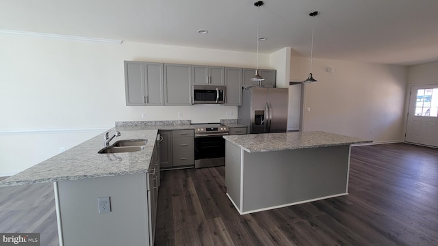 kitchen featuring sink, appliances with stainless steel finishes, kitchen peninsula, pendant lighting, and light stone countertops