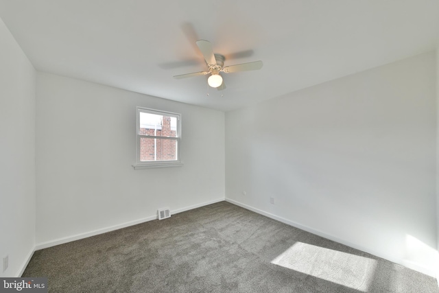 unfurnished room with a ceiling fan, baseboards, visible vents, and carpet flooring