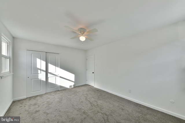 unfurnished bedroom with visible vents, baseboards, ceiling fan, and carpet flooring