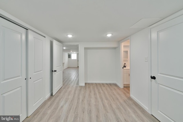 unfurnished room featuring recessed lighting, light wood-style flooring, and baseboards